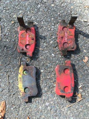 Rear brake pads - top down view. They swapped my red EBC pads for the yellow one on the bottom left.