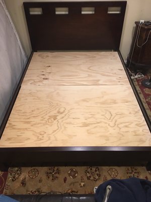 Custom cut plywood placed on my platform bed