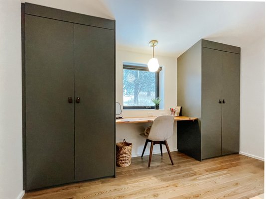 Bedroom built in closets fitted to pitched ceiling with floating desk in between