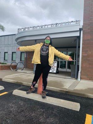 Me posing outside the library. With blue hair and a yellow rain jacket! What book character do o remind you of???