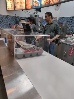 Worker's cellphone on top of spoons.