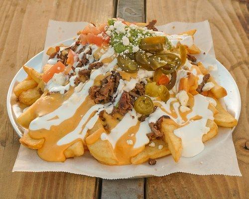 Our Asada Fries are topped with our homemade chile con queso!