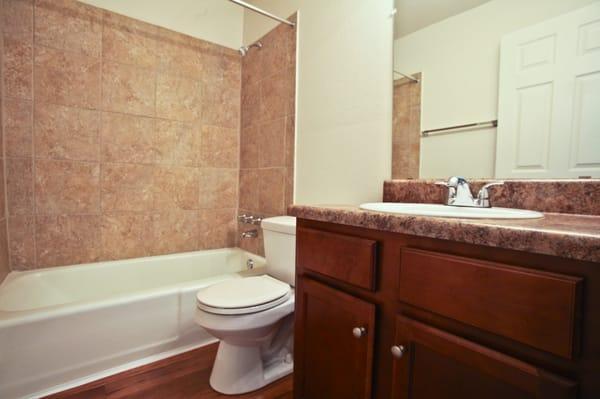 Upgraded bathrooms with wood floors, new tile and resurfaced counters