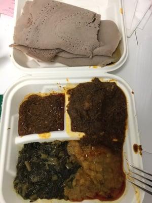 Yebeg (lamb) wat with miser (red lentils), shiro (chick peas) and gomen (collards) and a healthy serving of injera.