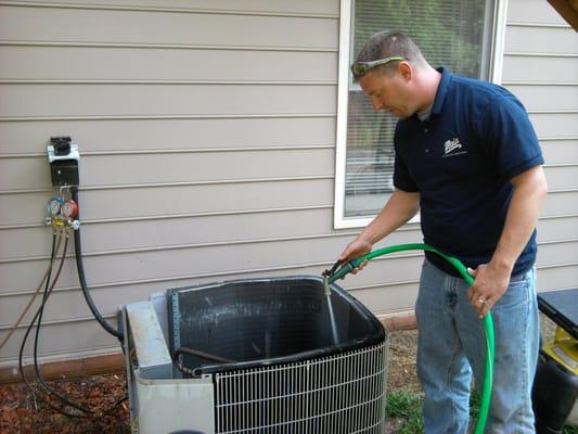 Here's Tom cleaning the coil of a customer's outdoor unit.  One of the many items provided with a residential maintenance agr...