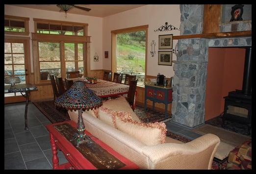 A view of the living room showing the fireplace/woodstove