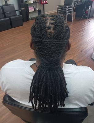 Men fishtail braid style on locs.