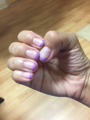 Gel nails with purple tips, lined with glitter!