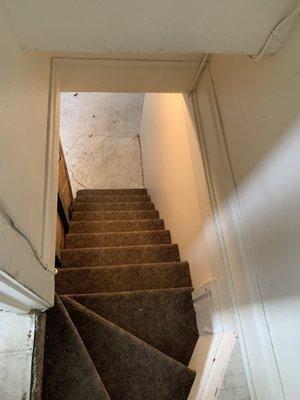 Wood and metal splinters on the basement floor and staircase.