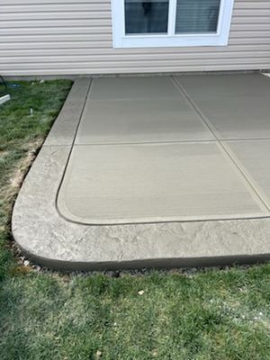 Broom finished patio extention with decorative stamped edge