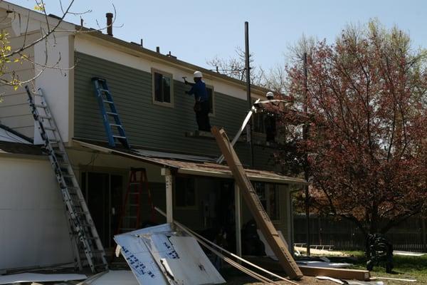 Replacing the back elevation with new premium vinyl siding.