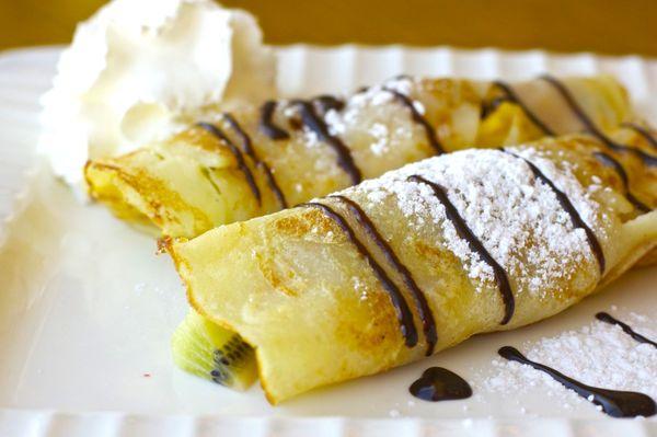 Fresh fruit crepes with chocolate sauce and whipped cream