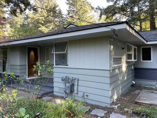 Three colors-eaves and trim, upper wall and lower wall--plus the brick. Plenty of masking off and careful cutting in.