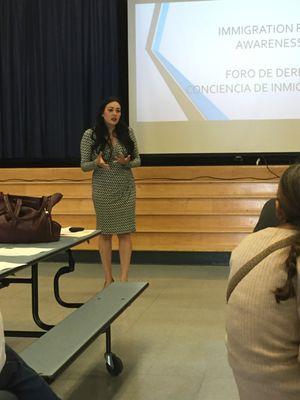 Attorney Garcia giving an immigration talk for families at a school.