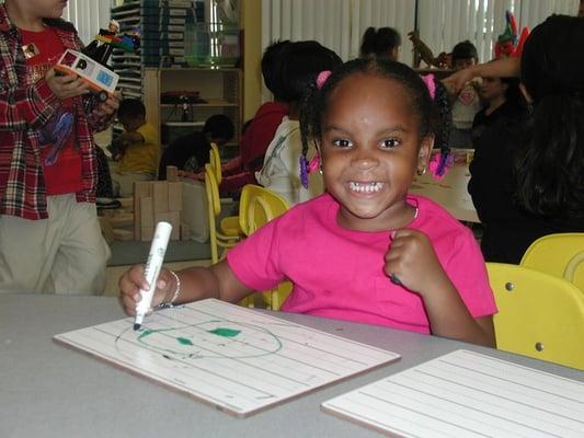 Child in school at St. Anne's - it's a happy place!