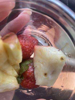 The fruit cup with mold on the strawberries