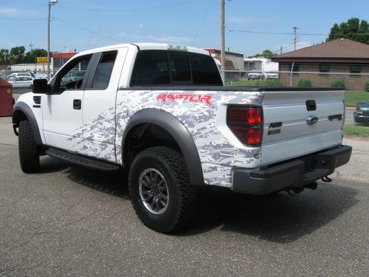 Custom Raptor and camo graphics designed, produced and installed on customer vehicle