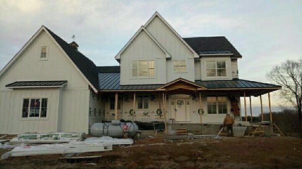 Metro Steel Construction customized this home's roofing experience with an asphalt roof accented with Standing Seam panels...