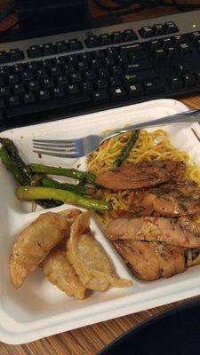 Various lunch items. Yakisoba noodles, teriyaki chicken and gyoza.