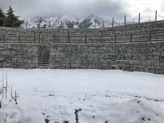 Two tier retaining wall dropping 20 feet.  Spanning 225 feet (425 total with the two walls).