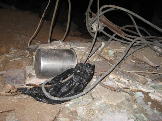 dangling wires and trash in the crawl space