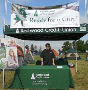 A volunteer at RCU's booth at the Rohnert Park American Cancer Society Relay for Life