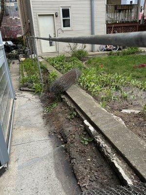 Removal of old poles in a chain - link fence demolition