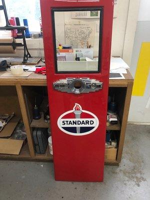 Decals applied to front of newly restored collector gas pump.