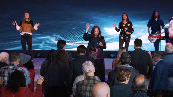 Pastor Barbara Perdue on the main stage at Charis Christian Center church.