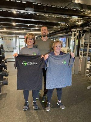 Here, two of our members earned Fitness By Design shirts when they completed their first 20 workouts.