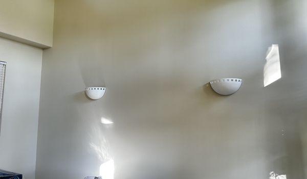 Installation and power up of two wall-mounted sconces.