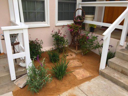 Small Porch area with stone steps and decomposed granite and watering plants