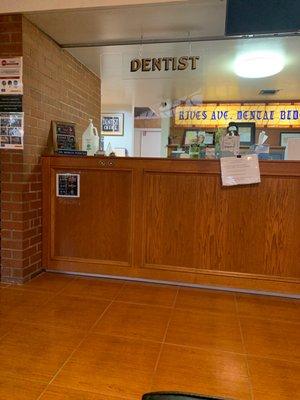 Front desk with hand sanitizer & Covid regulation.