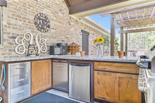 Outdoor kitchen is a must, give AGY a call for all of your construction needs.