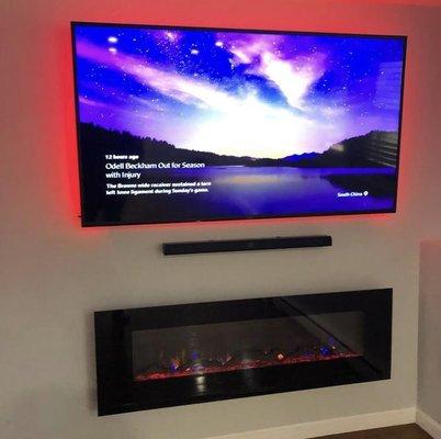 Here is a display of our customers 75" Sony 4K OLED TV installed at the proper height and level. Along with a black 65" recessed fireplace