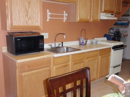 Suite: Kitchen, stove, coffee, microwave, refrigerator, pots/pans, dishes.