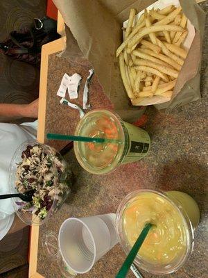 tropical smoothie, green monster smoothie, fries, and kale crunch salad with lemon citrus