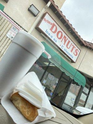 Ice cold coffee with A cream cheese danish warmed up and on