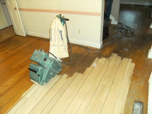 Here's and old hardwood floor that needed lots of help. We sanded the floor, stained it and applied polyurethane. Happy customer