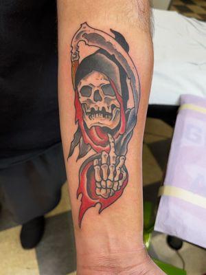 It is a reaper tattoo hold its middle finger up.