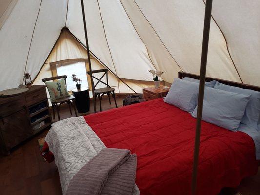 Comfortable bed and little essentials for glamping