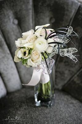 Modern bridal bouquet of ranunculus calla lilies, anemones and black grass with hand made wire leaves.