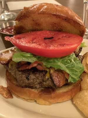 Bacon cheeseburger and the biggest red tomato. Cooked medium perfect. The chips are home made and slice so thin they are more like a crisp.