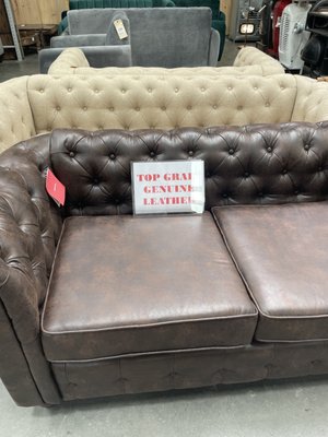 Faux leather couch with "genuine leather" signage