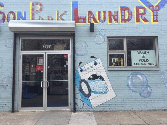 Cutely painted exterior except for the cartoon washer spitting up suds!