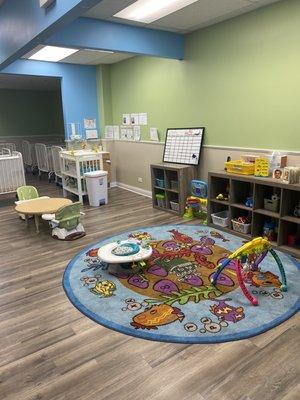 Infant room carpeted area, feeding area and diaper changing station