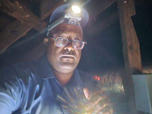 Crawling in the attic to secure a pipe.