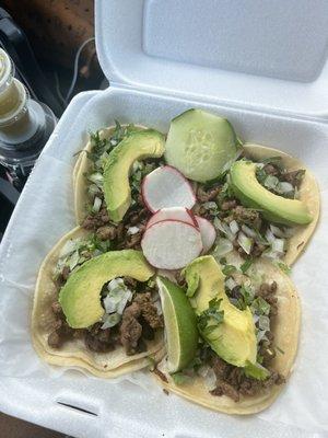 4 steak tacos with cilantro, onions, and avocado