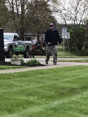 Blowing off driveway and sidewalks after mowing, trimming and edging.