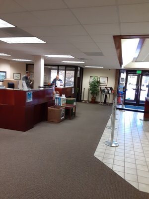 Workers gossiping instead of helping customers seated in waiting area.